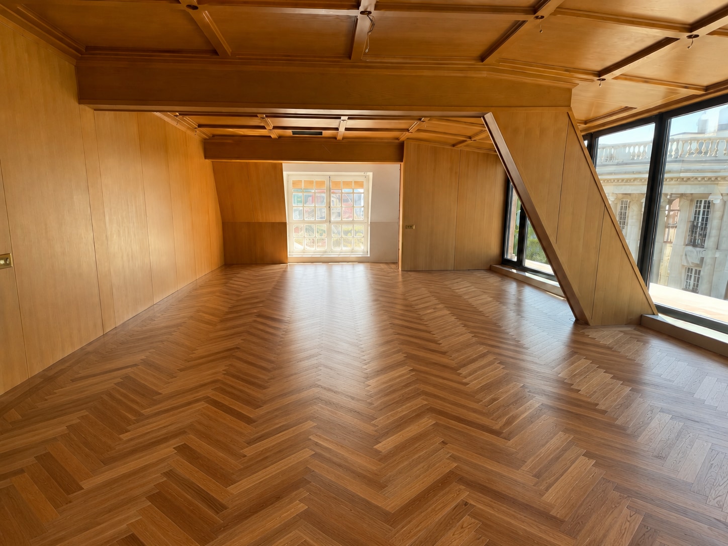 After — the same salon completed in HARO natural oak herringbone