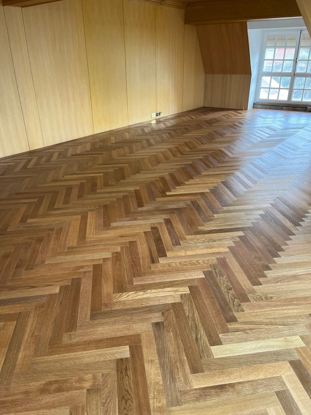 The finished oak floor aligned with the room's timber panelling