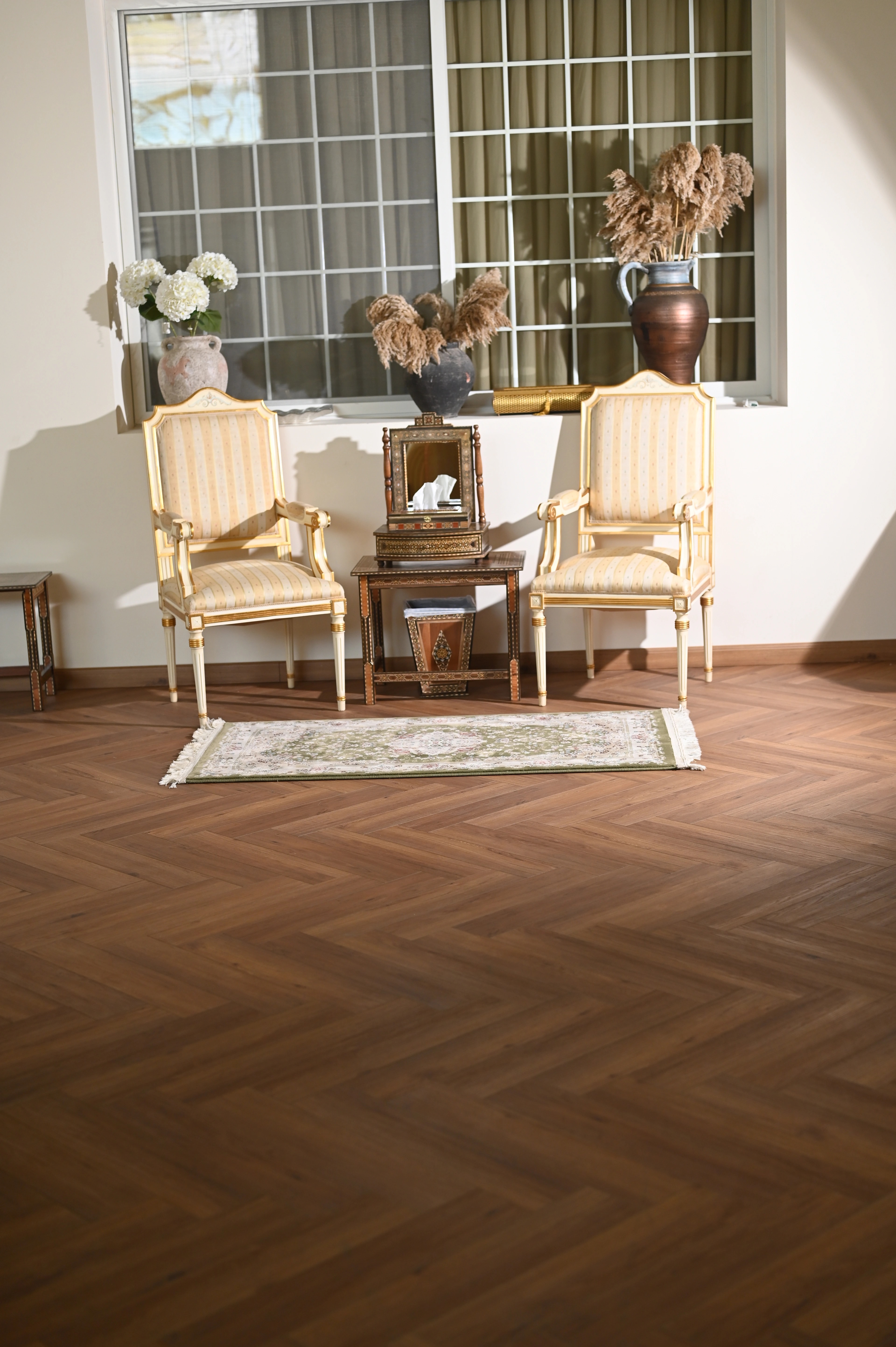 A private residence in warm herringbone oak, symmetric seating by a bright window