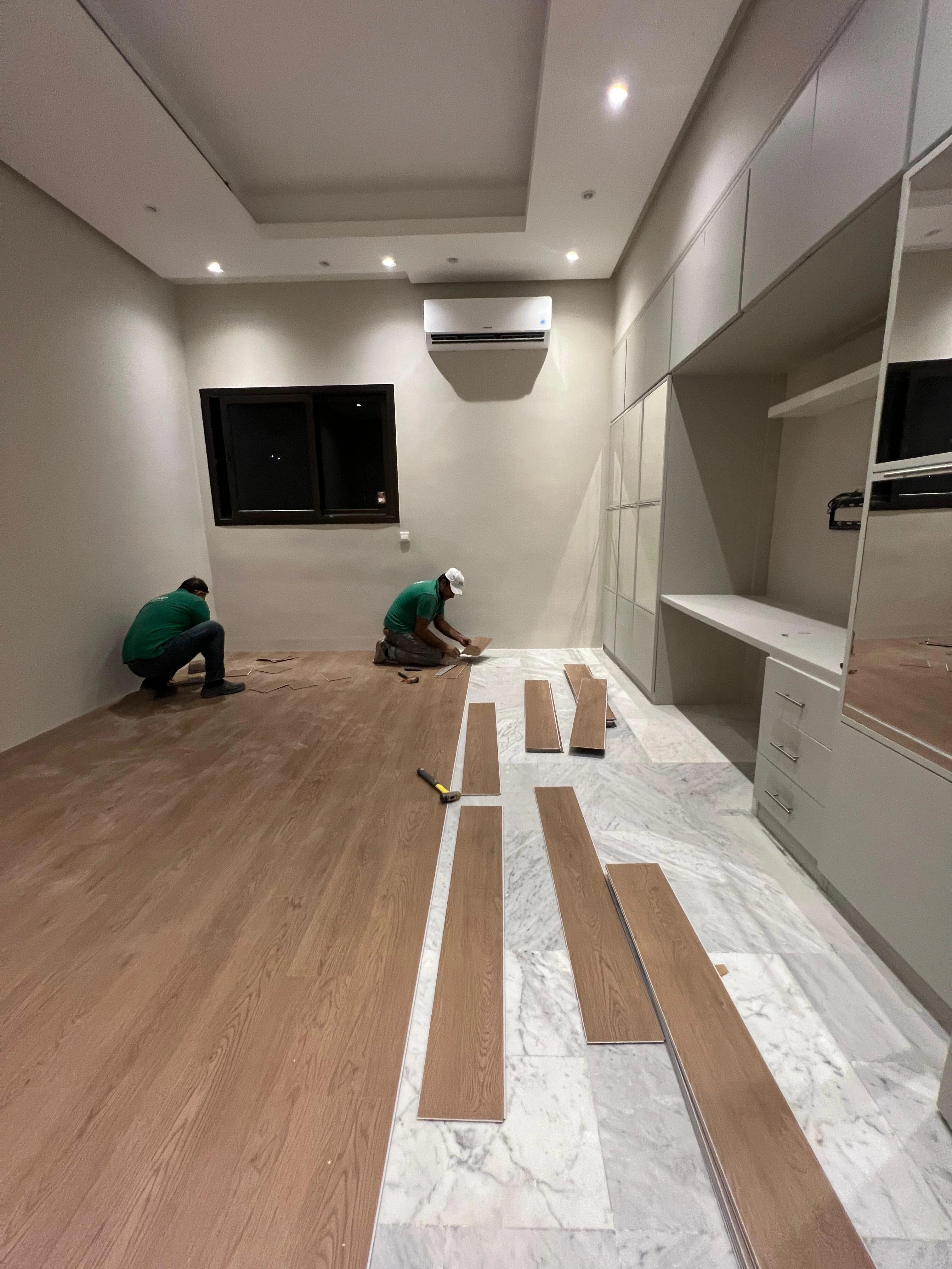 Warm oak planks set out from the bedroom's long wall