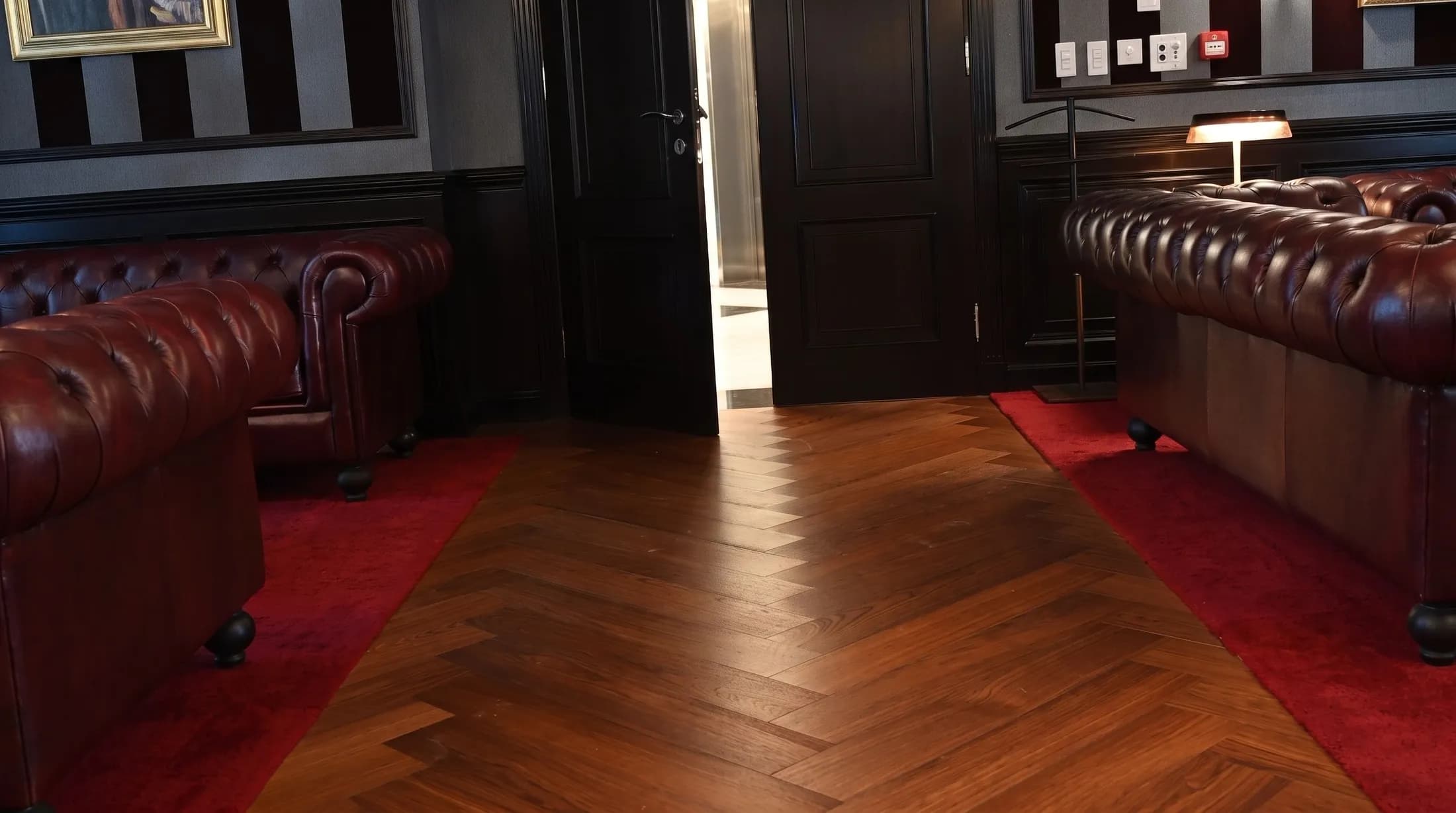 Herringbone parquet carried through a panelled threshold