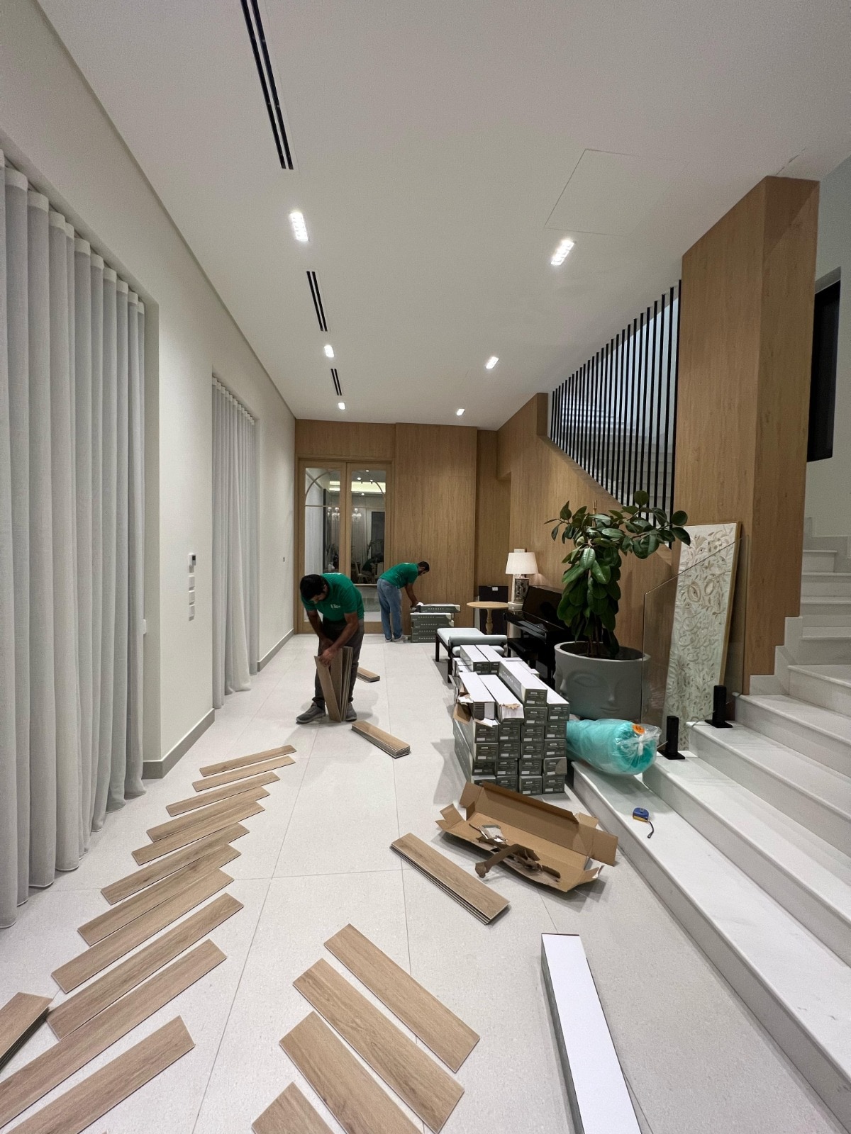 Herringbone flooring being set out beside a residential staircase