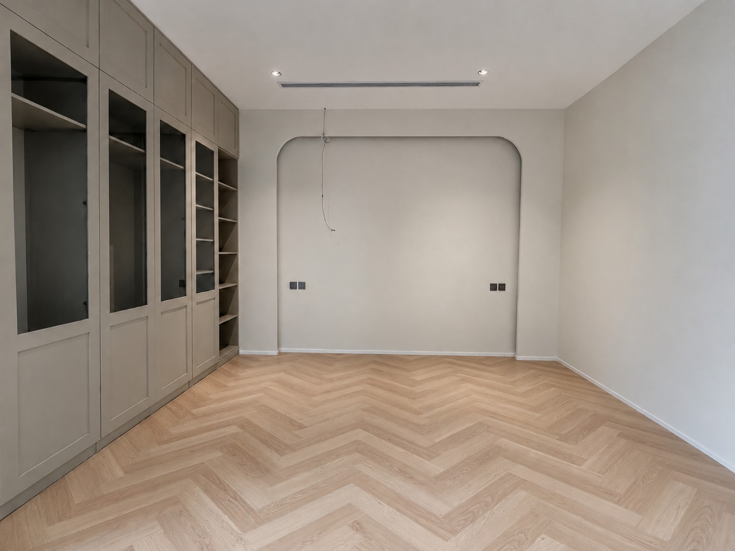 After — the same fitted room completed in pale herringbone