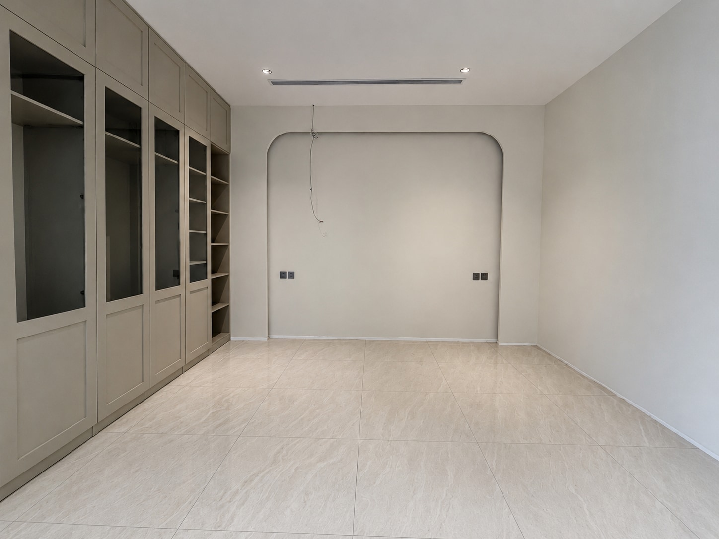 Before — a pale fitted room before its herringbone transformation