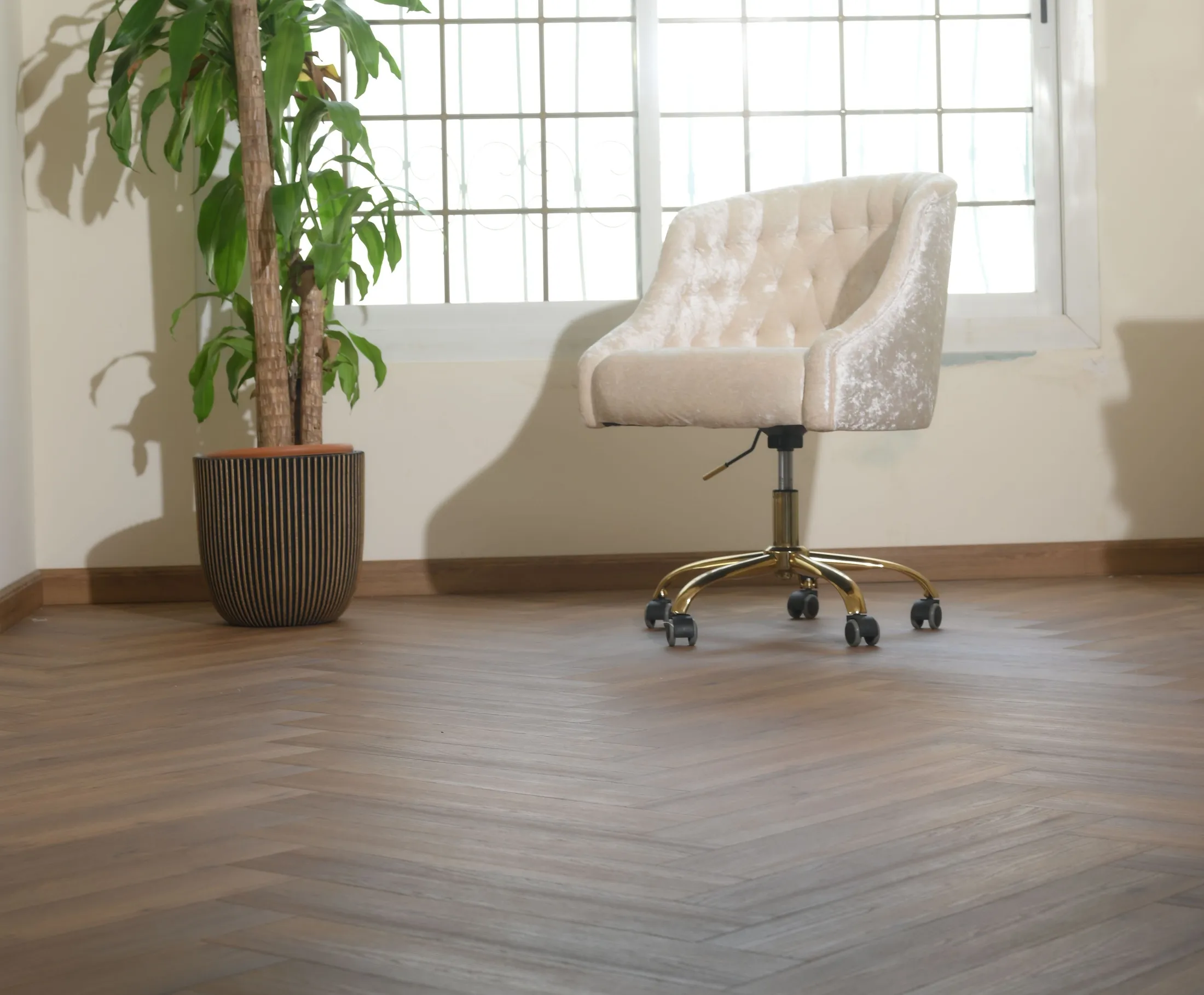 Herringbone oak running the length of a bright reception room