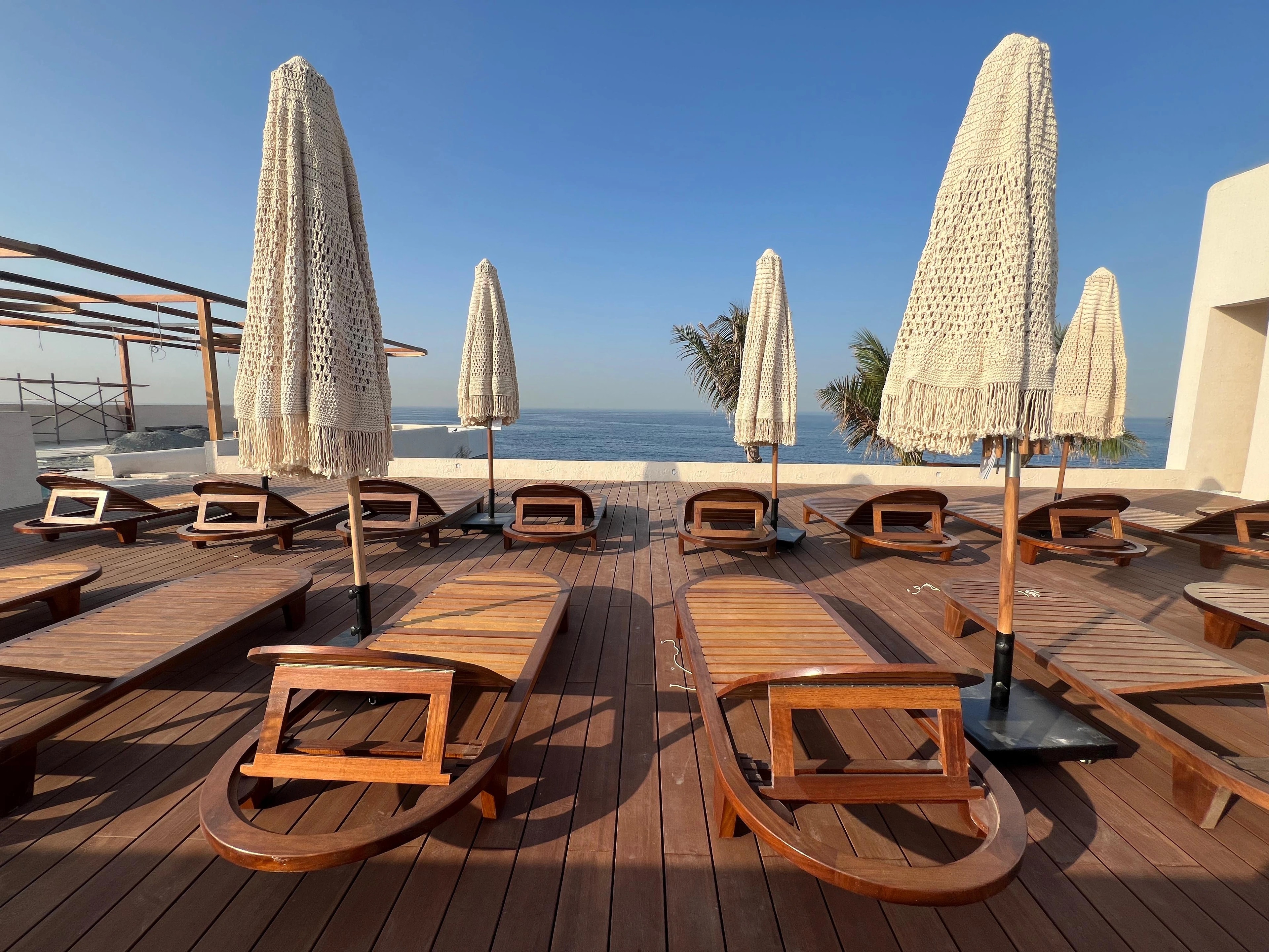 Long rows of timber decking and loungers facing the water